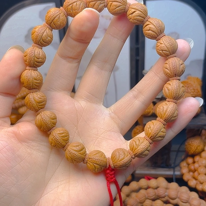 游***！菩提籽类龙纹桃核手串