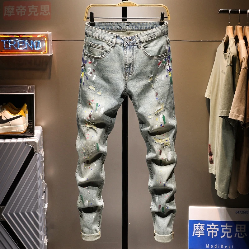 潮牌油漆裤子男士牛仔裤男复古破洞泼墨痞帅修身小脚韩版2025新款