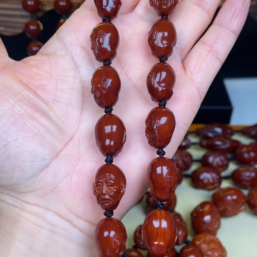 孛***少橄榄核吊坠罗汉手持