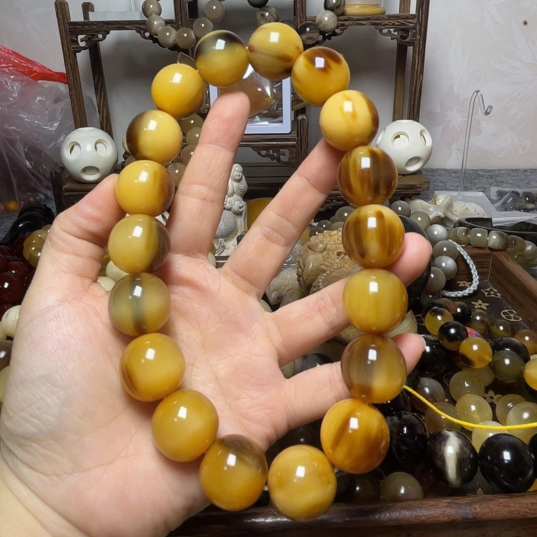 唐***品石英石纯铜金丝牦牛角手持花色