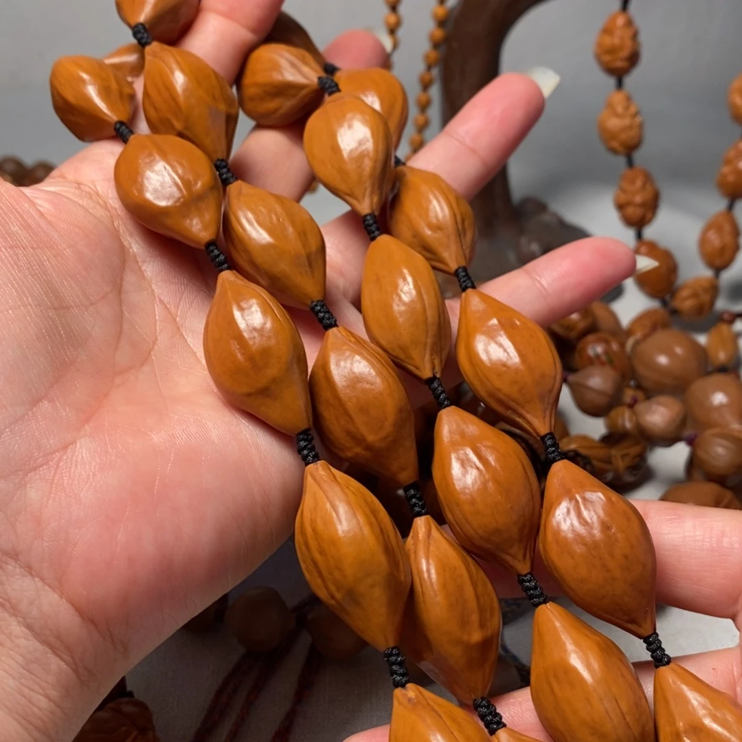 指***儿橄榄核吊坠素核脖挂