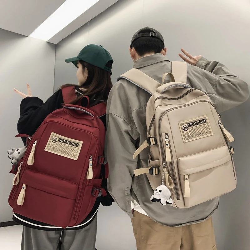 春夏季简约旅行双肩背包电脑背包休闲纯色标签初高中生大容量书包