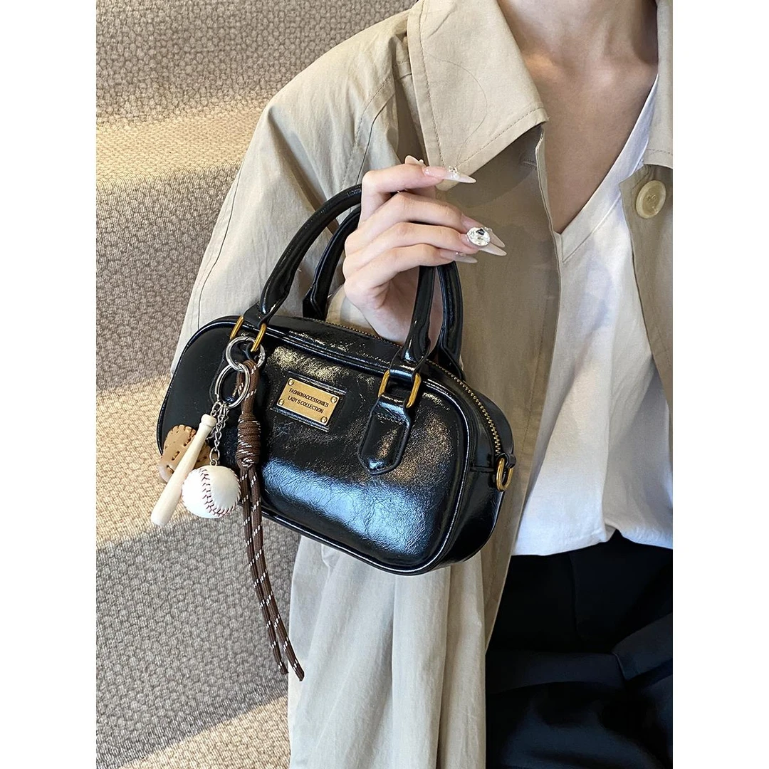 高级质感小包包女2025春夏新款手提枕头包波士顿设计感通勤斜挎包