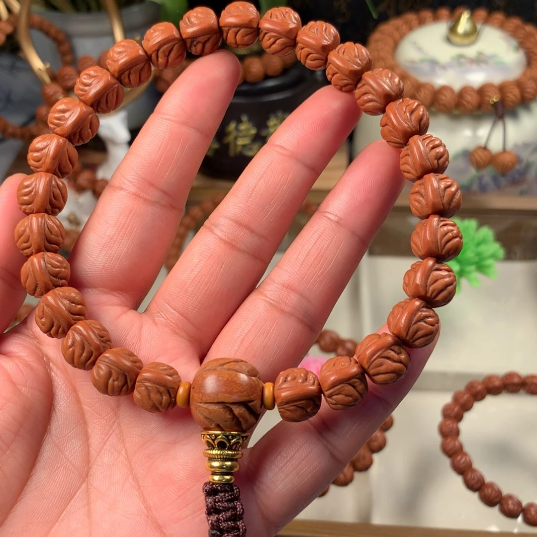 宇***男桃核吊坠野生籽手持11