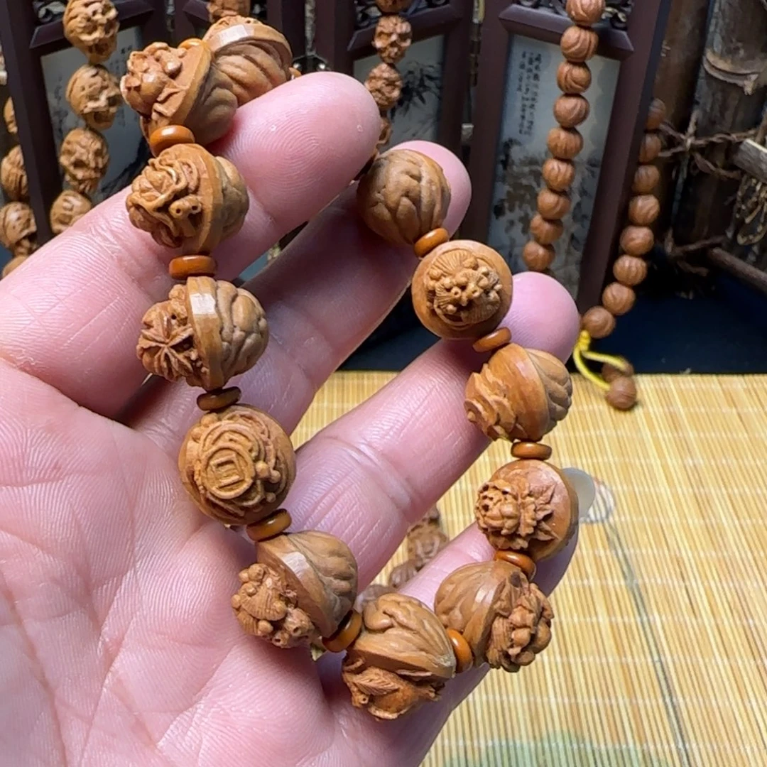 炜***烨纯手工雕刻龙纹桃核多宝手串