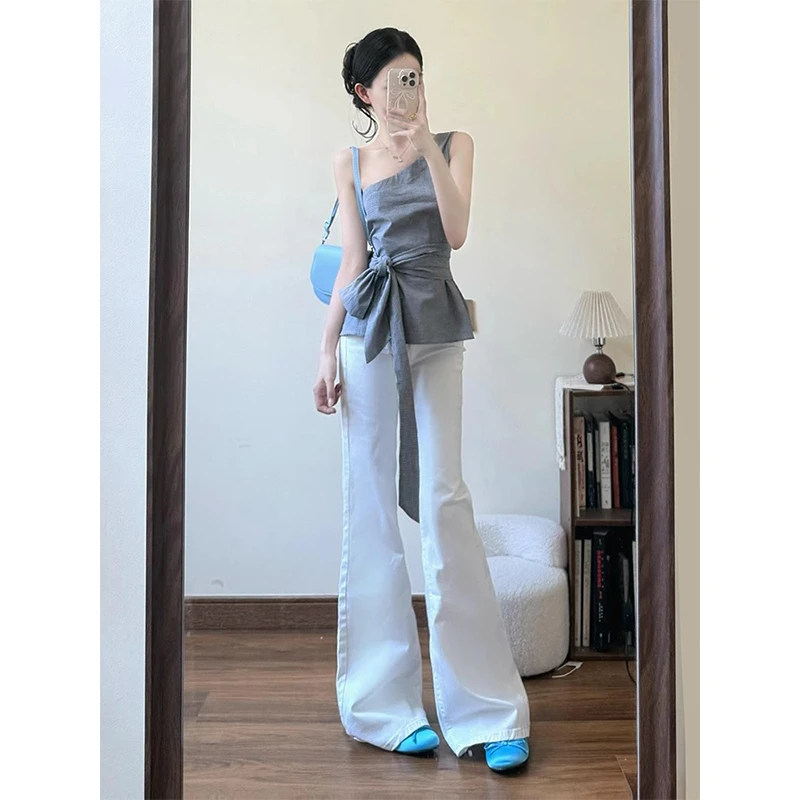 韩系套装女2025夏季设计感格纹斜肩系带蝴蝶结上衣显瘦微喇牛仔裤