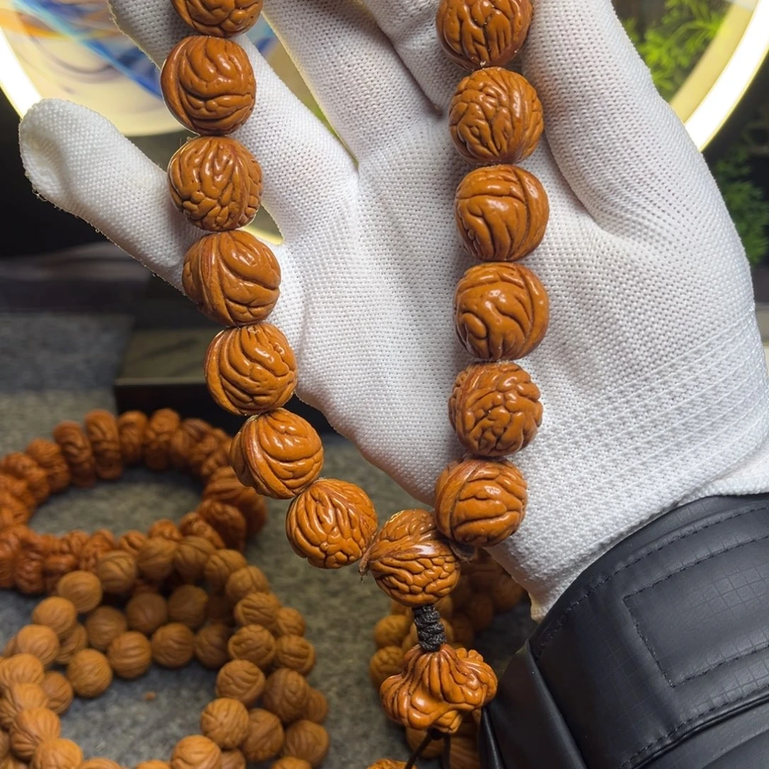 阜***甜桃核吊坠霸王龙手持