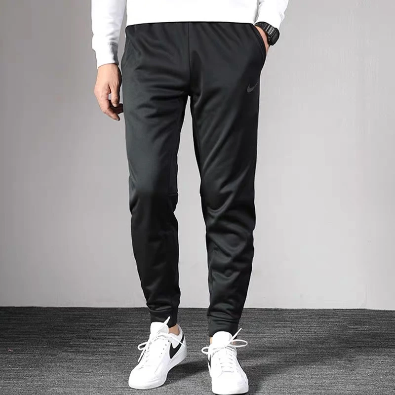 NIKE/耐克秋冬男款百搭梭织休闲运动裤加绒束脚裤保暖卫裤55/56