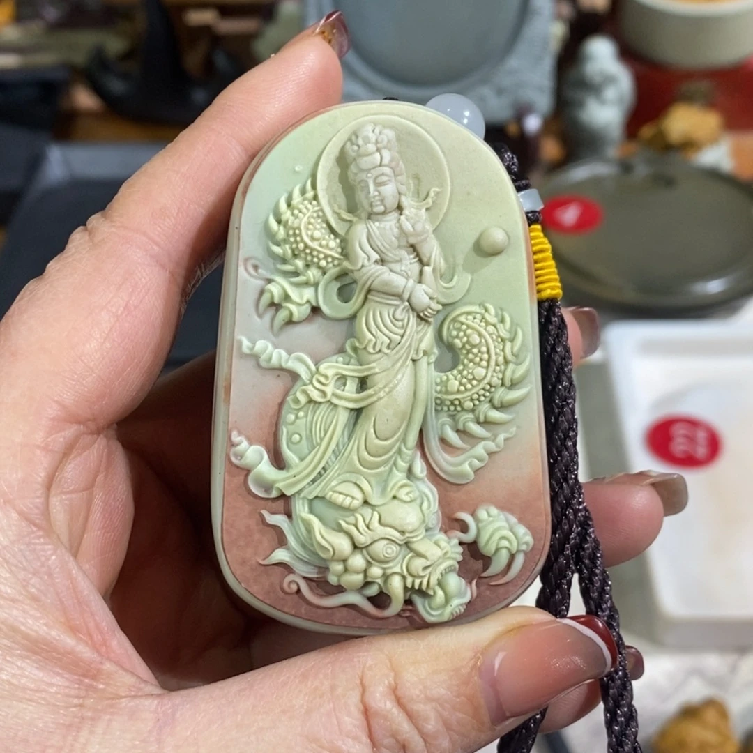 冬***、石材紫袍玉带石御龙观音手把件