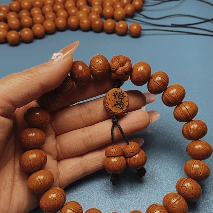 繁****宁桃核手持算盘17花皮色差21颗