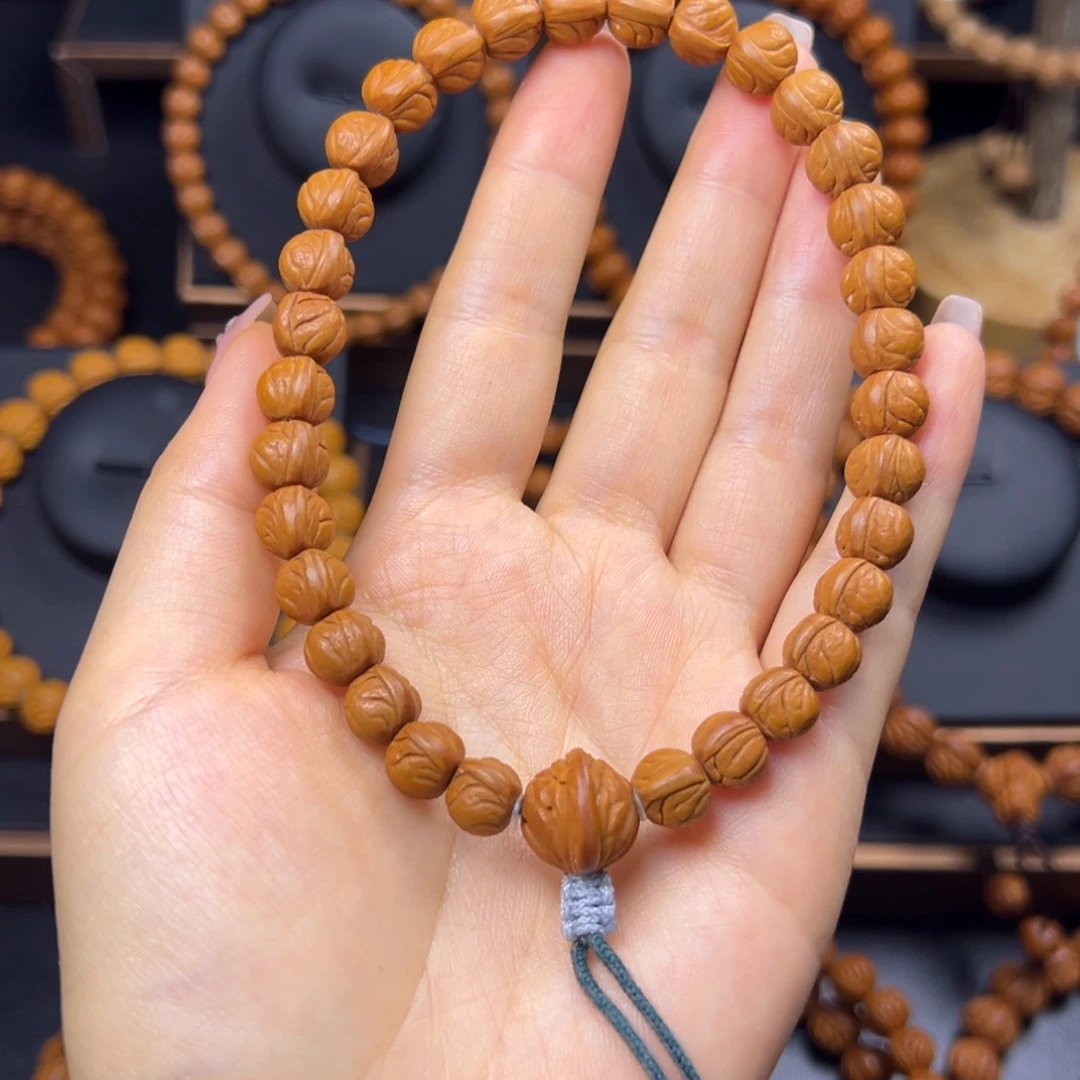 鱼***飞桃核手串野生玉龙脊0.9