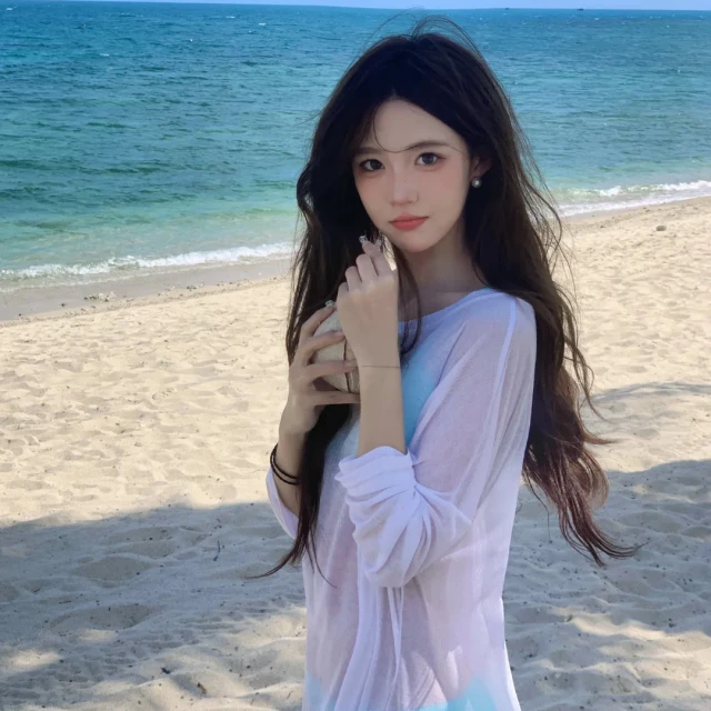 白色微透长袖防晒空调罩衫女夏季薄款性感辣妹海边外搭针织衫上衣