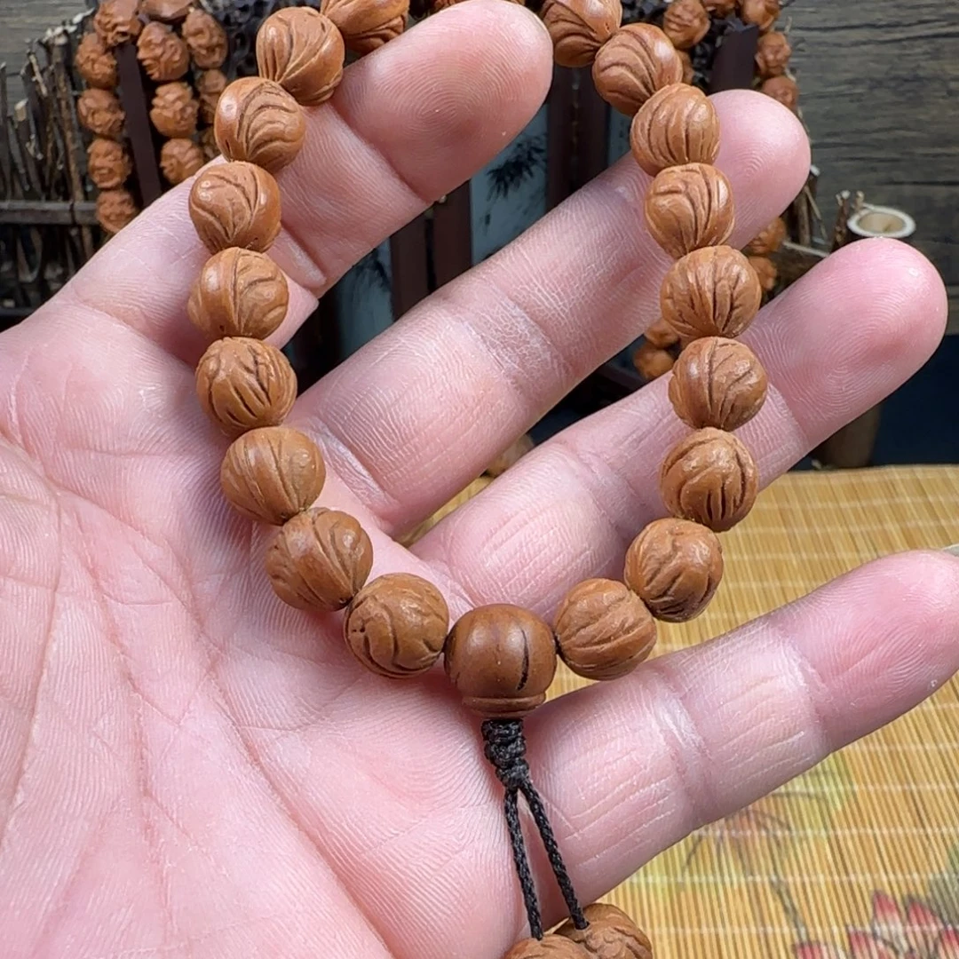 龙纹桃核玉龙脊手串配一颗纯手工单籽