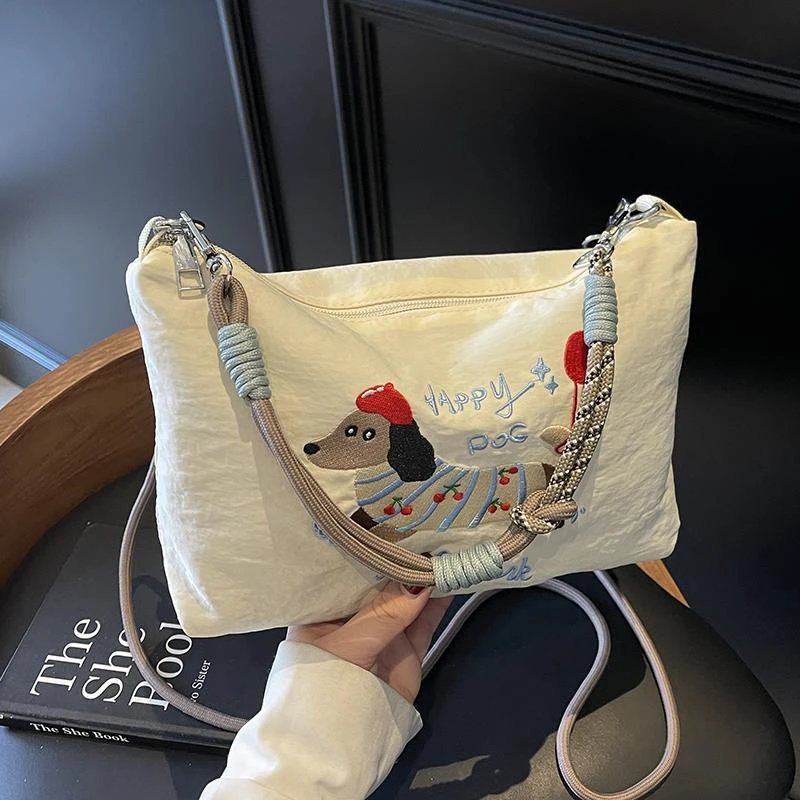 今年流行帆布手提包包女2025新款时尚网红腊肠狗单肩包通勤斜挎包