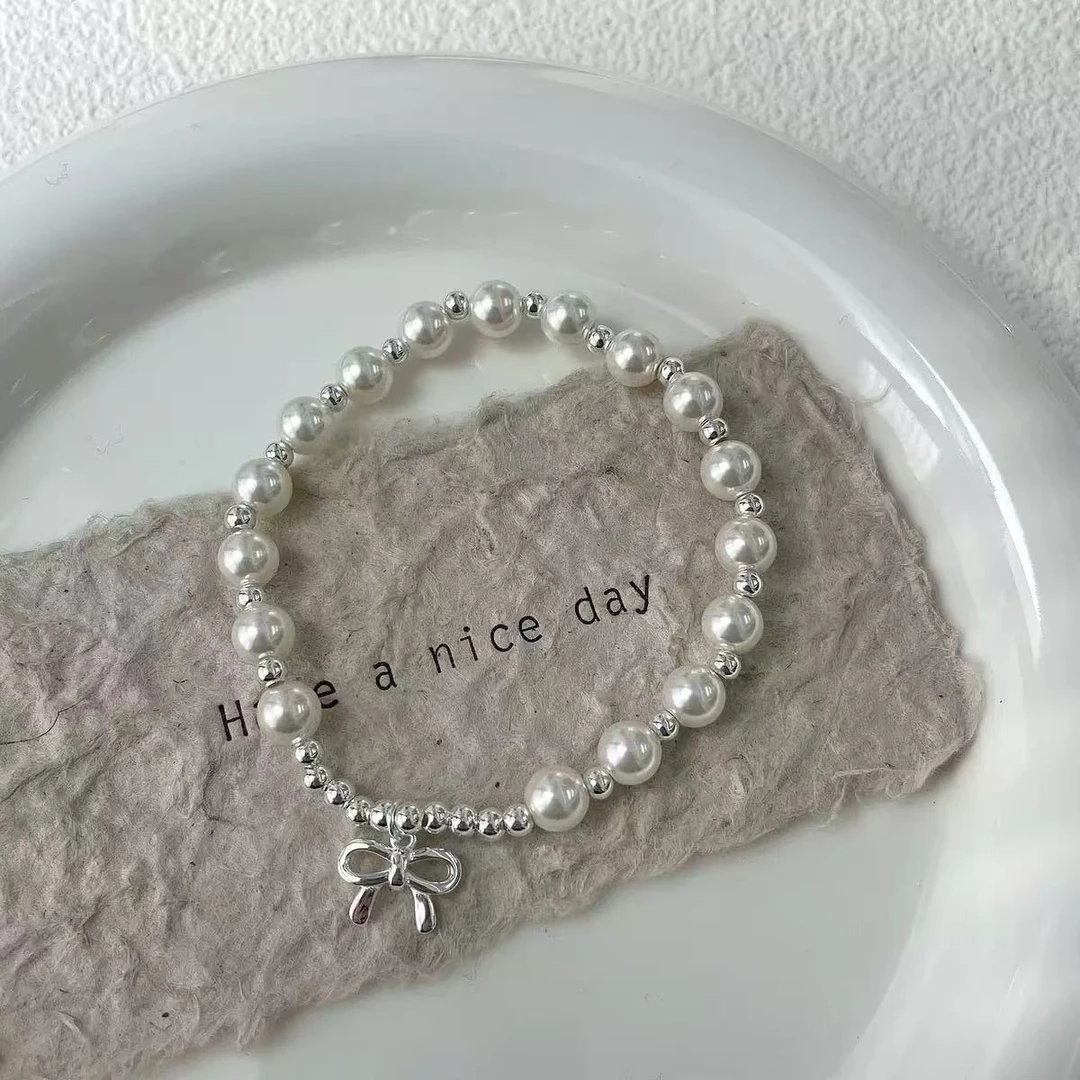 925银仿珍珠手链 S925纯银手串蝴蝶结手链女高级感轻奢弹力绳手串