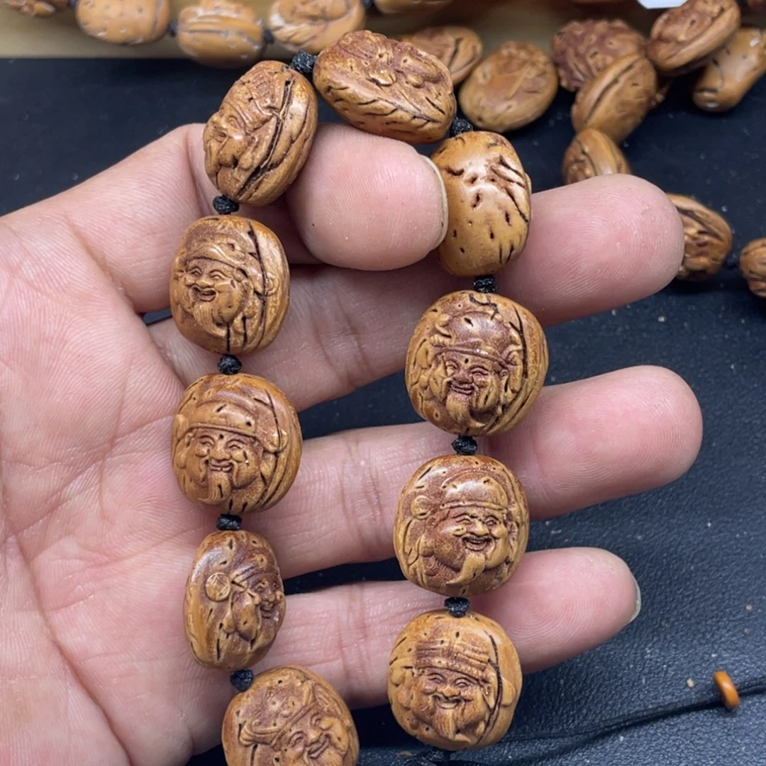 桃核雕刻财神头手串