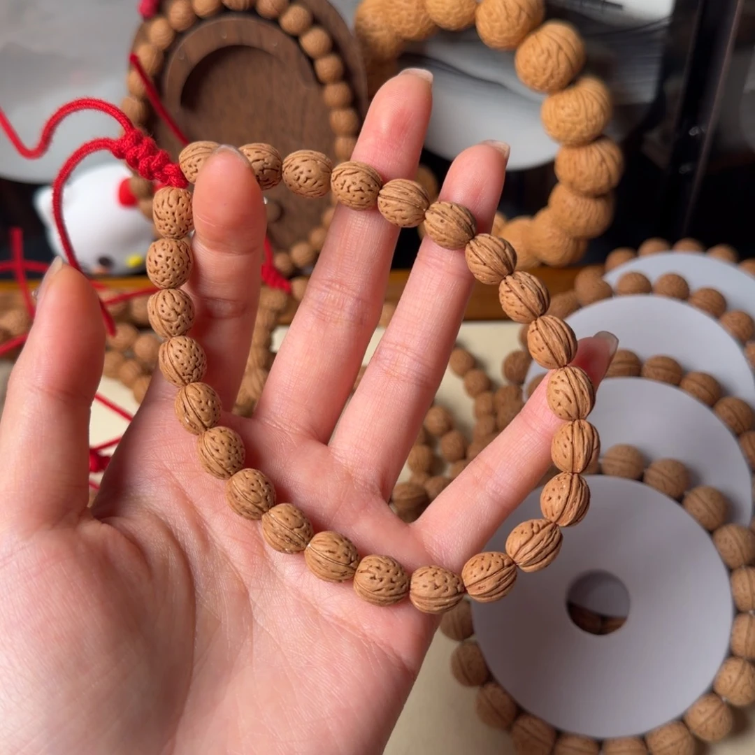 彼***开0.9野生钱袋子桃核吊坠