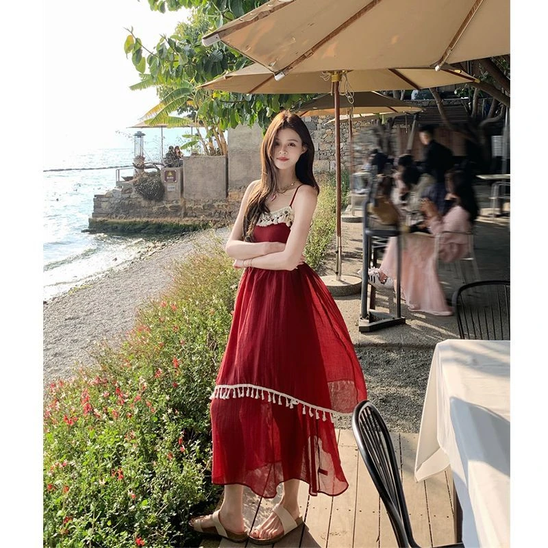 海边度假流苏拼接吊带连衣裙秋夏新款设计感不规则大摆长裙女通勤