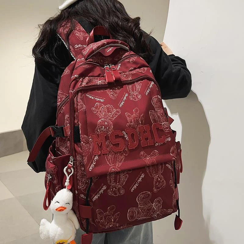 书包女生大学生高中学生酒红色大容量背包初中生小学生男款双肩包