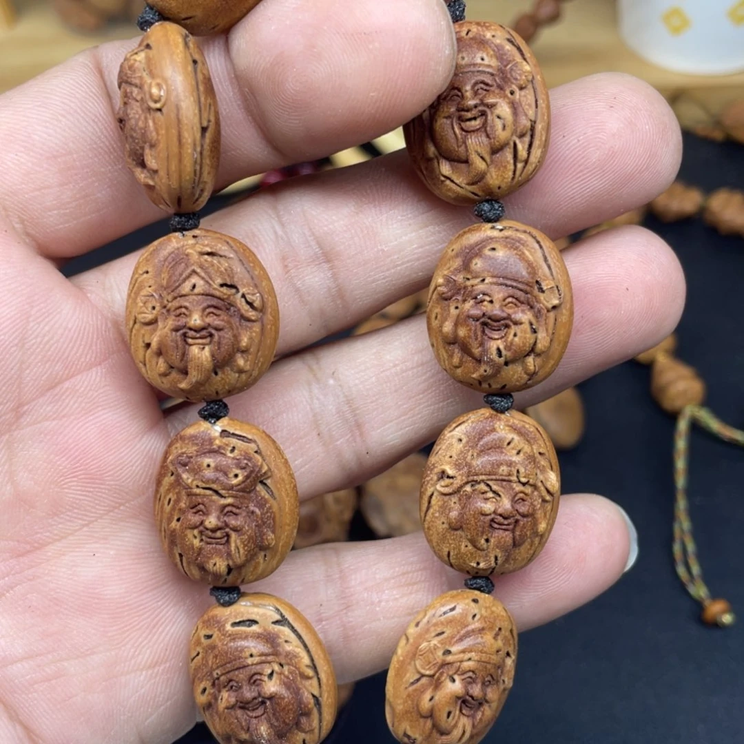 桃核雕刻财神头手串