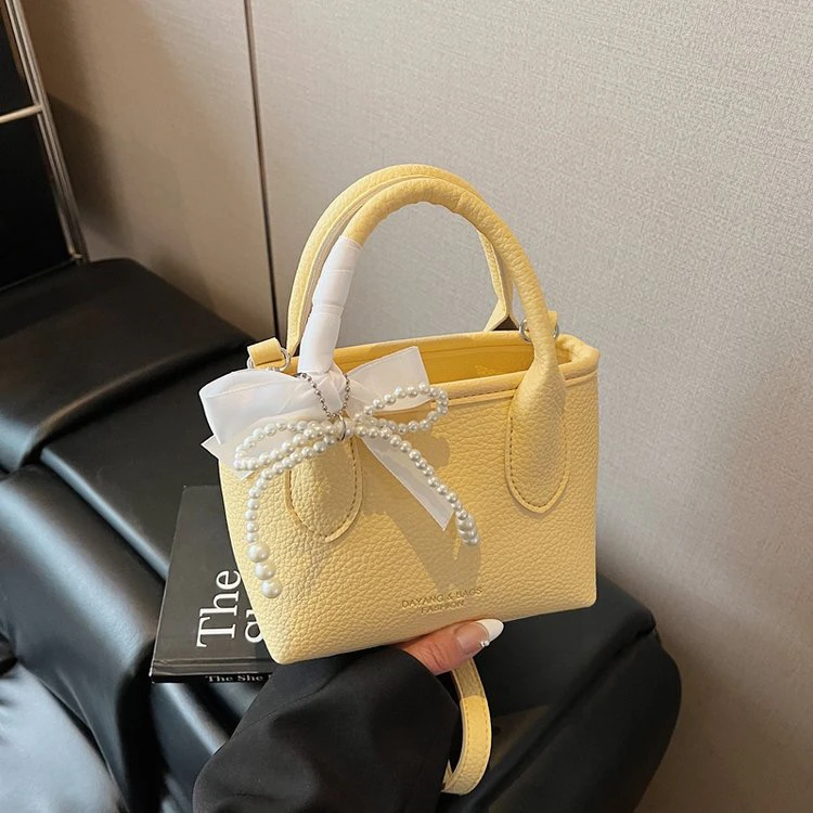 夏天夏季小众超火水桶包包女2025新款蝴蝶结拉链手提斜挎包手机包