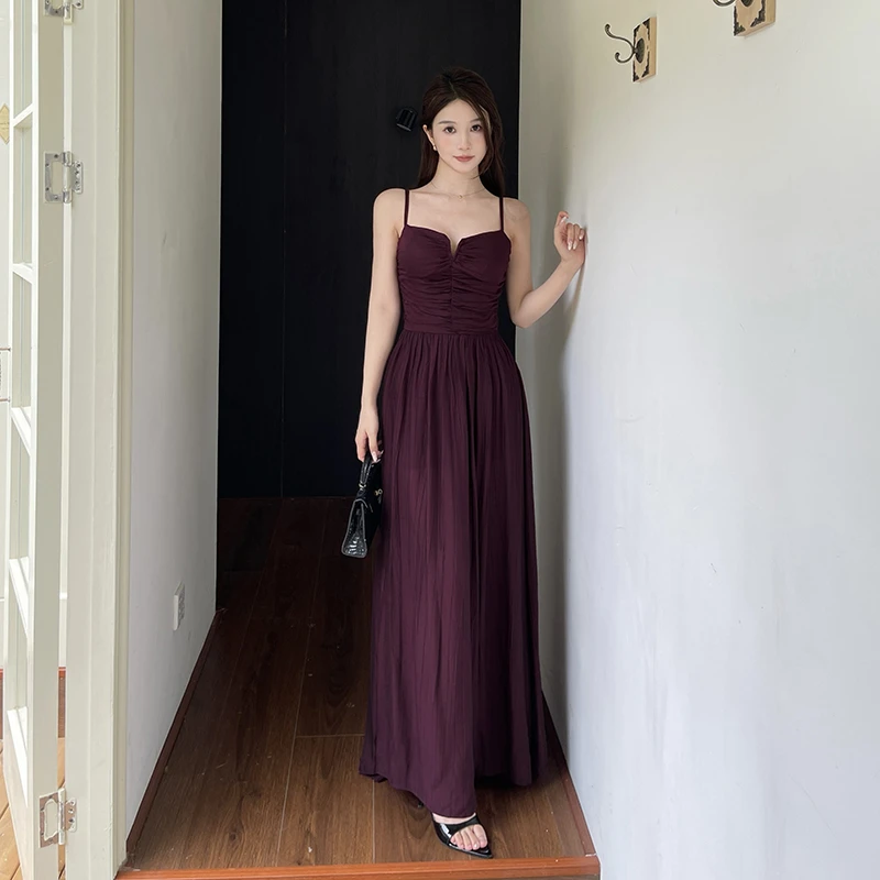 法式紫色镂空开叉吊带连衣裙2025夏季新款设计感露背绑带收腰长裙