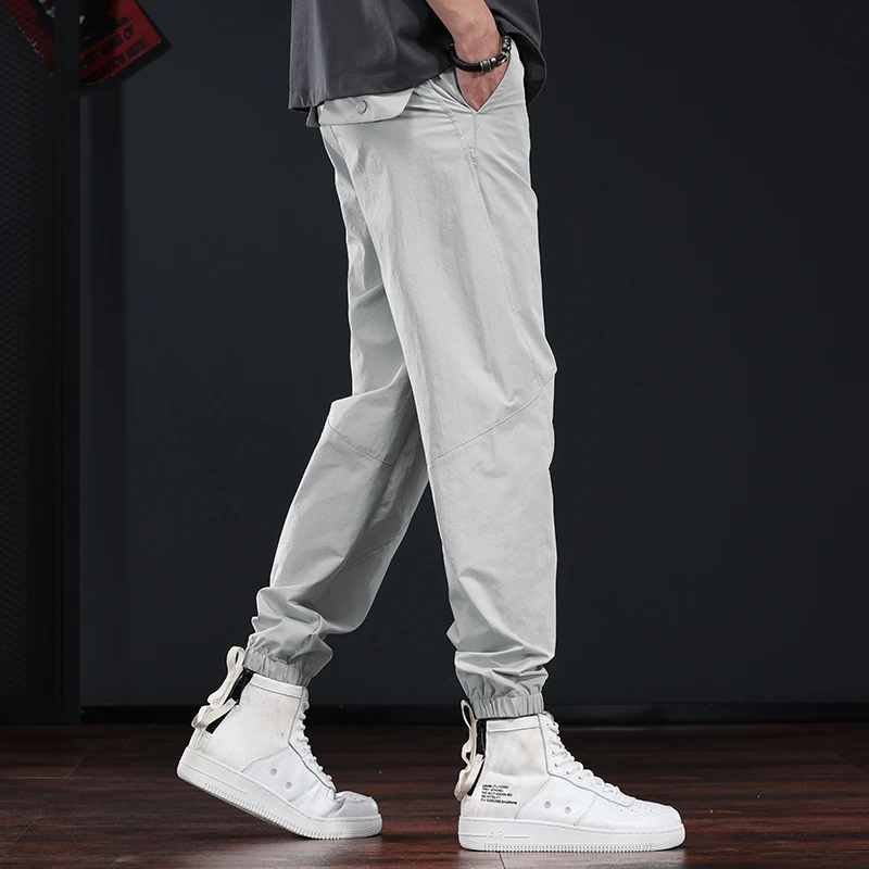 夏季浅色休闲裤男2025新款潮流梭织运动裤英伦雅痞百搭哈伦束脚裤