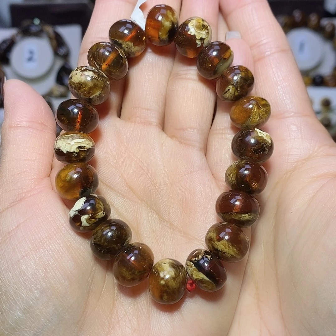 莫***可琥珀未镶嵌裸石血底溶洞12+