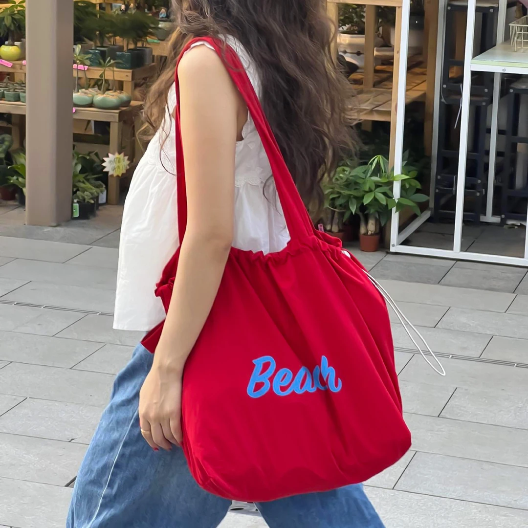 韩国小众字母帆布包休闲英文印花抽绳单肩手提包