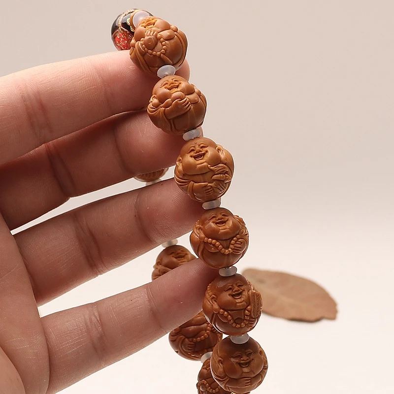 铁核手工雕刻橄榄核包衣小弥勒精品文玩尺寸：1.6×1.7手持cm