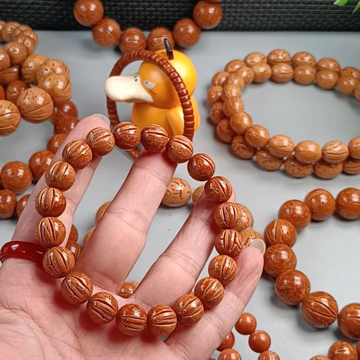 ¥***℅桃核手串铁籽密纹黄皮10.9