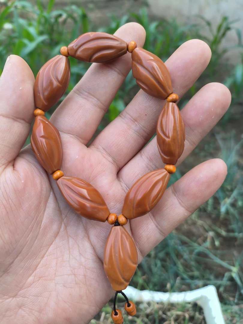 精品素核打磨雕刻扭转乾坤尺寸：1.7×3.3左右橄榄核手串文玩手串