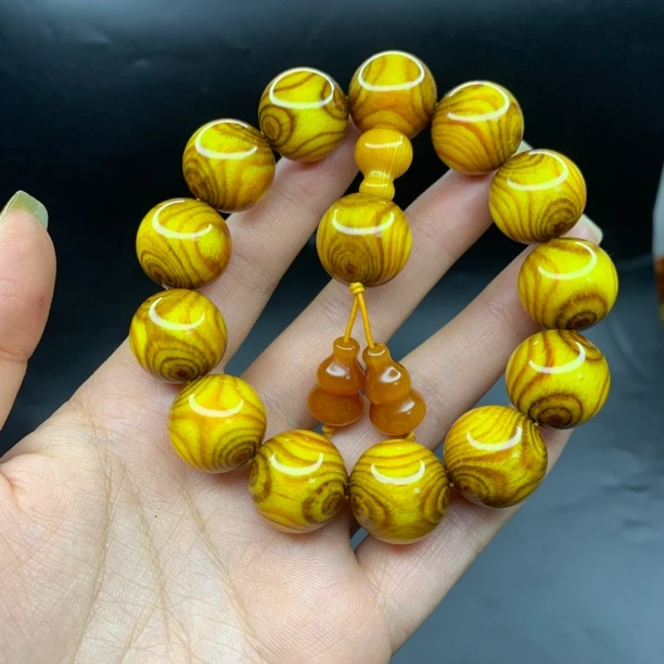 精品黄油琥珀木鬼脸手串