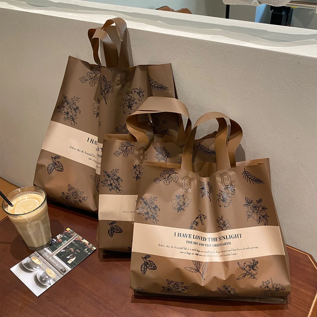 新款磨砂褐色花花服装店手提袋加厚高档礼品胶袋购物袋塑料包装袋