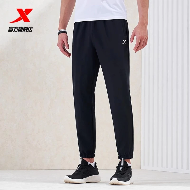 XTEP/特步防泼水运动长裤男春秋新款跑步训练束脚男子梭织运动裤