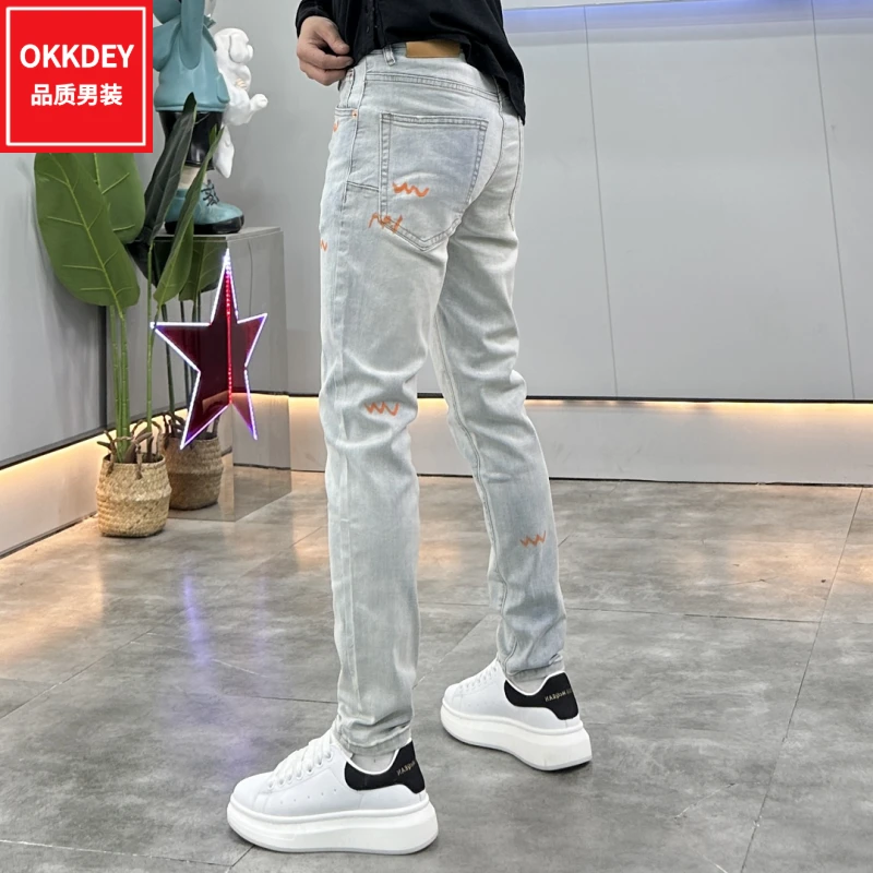 okkdey2024秋冬新款高档牛仔裤男士潮牌印花长裤韩版修身小脚裤