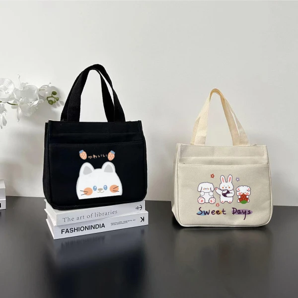 拉链外侧兜帆布手提包多口袋妈咪包卡通便携饭盒包通勤女包零食包