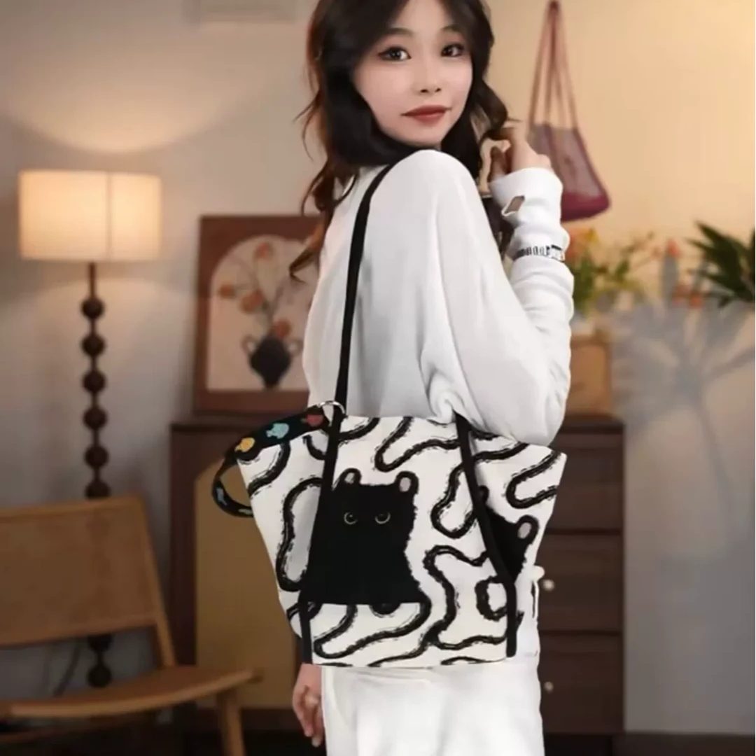 白缇雅2025韩系休闲水桶包新款大容量猫咪单肩包小众设计感斜挎包
