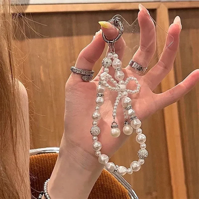 ins珍珠串珠蝴蝶结链条挂绳手机通用钥匙扣ccd相机包包包挂件女款