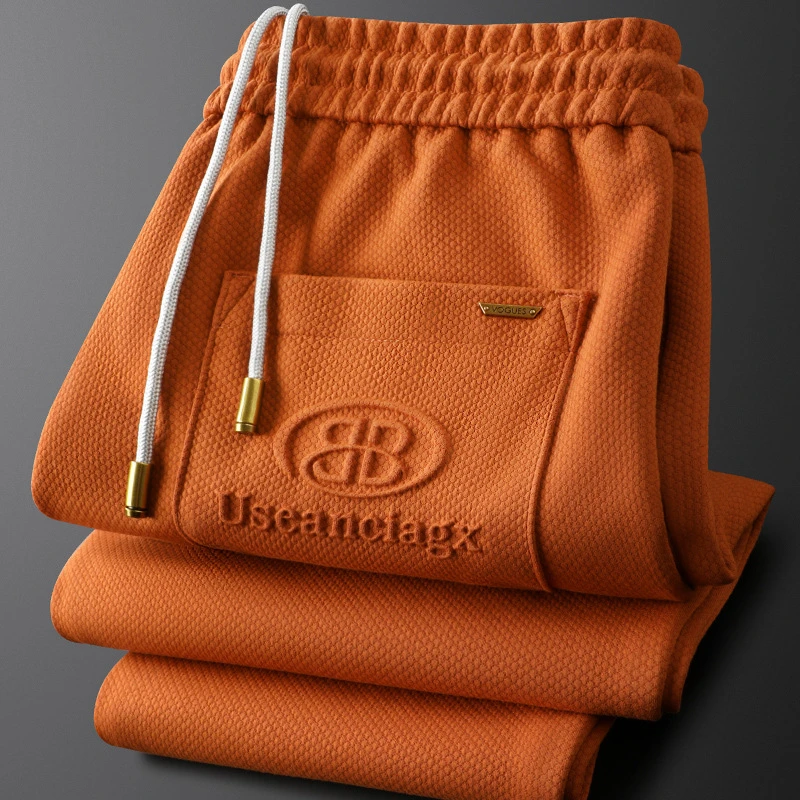 潮流亮色男士裤子桔色字母压花休闲裤男士秋冬修身百搭男士系带裤