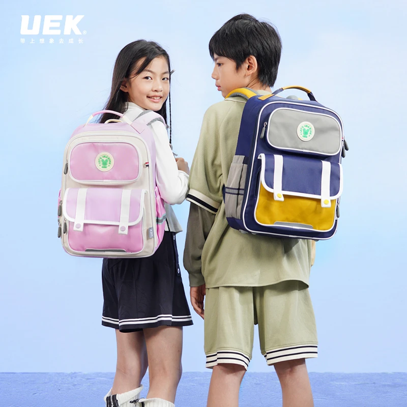 UEK小学生休闲透气护脊防水儿童超轻简约潮流韩版初中生英伦书包