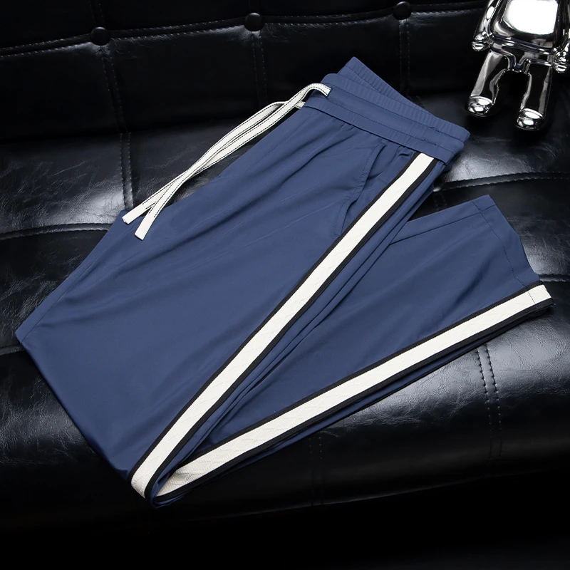 夏季薄款丝滑冰感蓝色休闲裤男士时尚织带拼接修身直筒运动卫裤潮