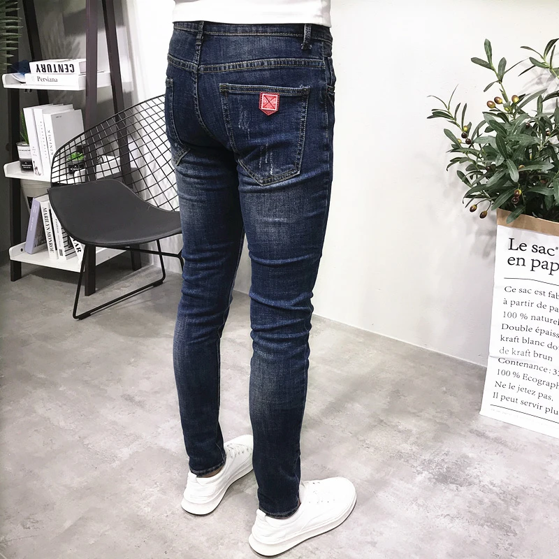 潮牌牛仔裤男秋新款深蓝修身小脚长裤男个性抓痕毛边裤脚社会网红