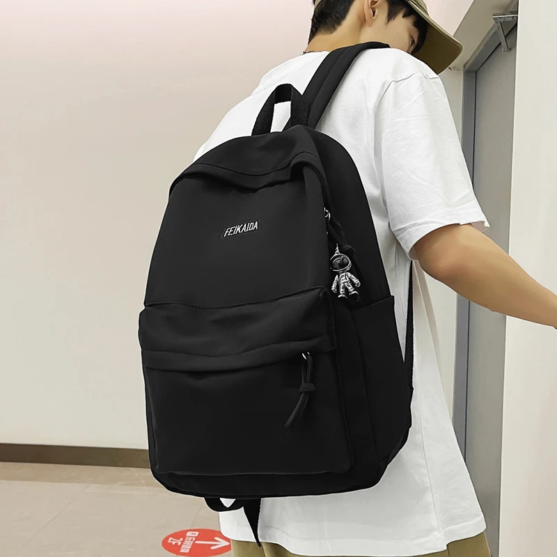 户外双肩包男士休闲小众潮流纯色轻便运动女大学生大容量双肩背包