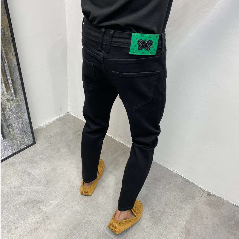 黑色潮流牛仔裤男2025秋季新款修身小脚裤百搭纯色韩版时尚九分裤