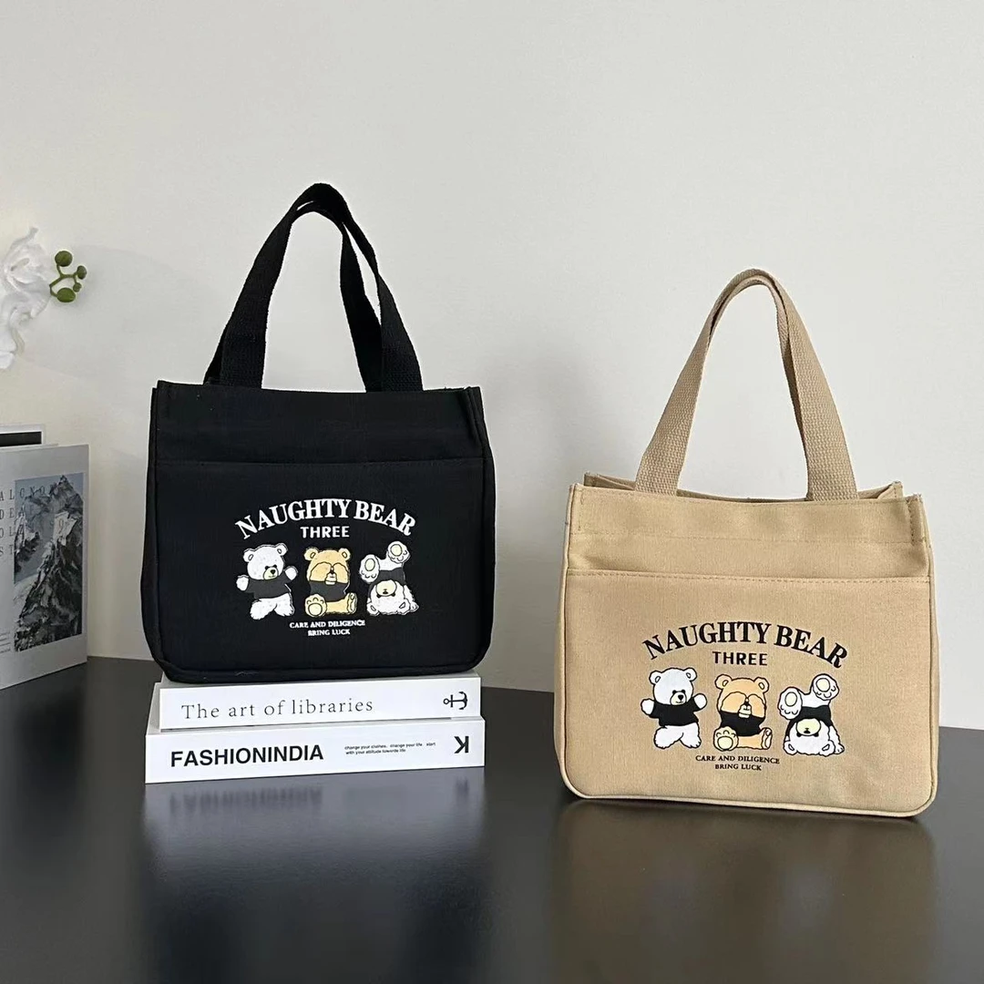 拉链外侧兜帆布手提包多口袋妈咪包卡通便携饭盒包通勤女包零食包