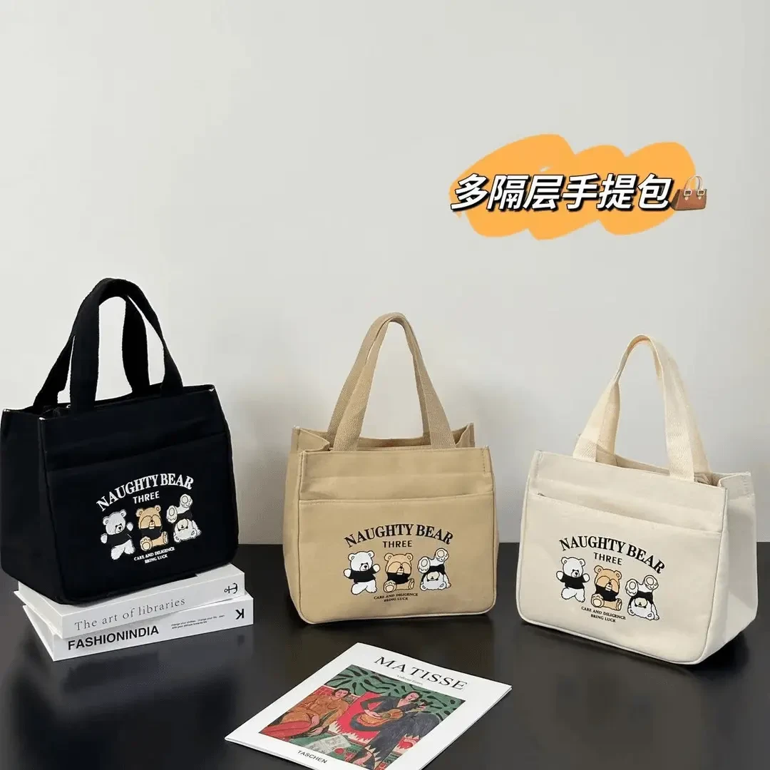 吉祥草拉链外侧兜帆布手提包多口袋妈咪包卡通便携通勤女包零食包