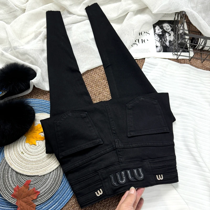 收腹提臀纯黑色三排扣加薄绒牛仔裤女秋冬显瘦小黑裤紧身小脚靴裤