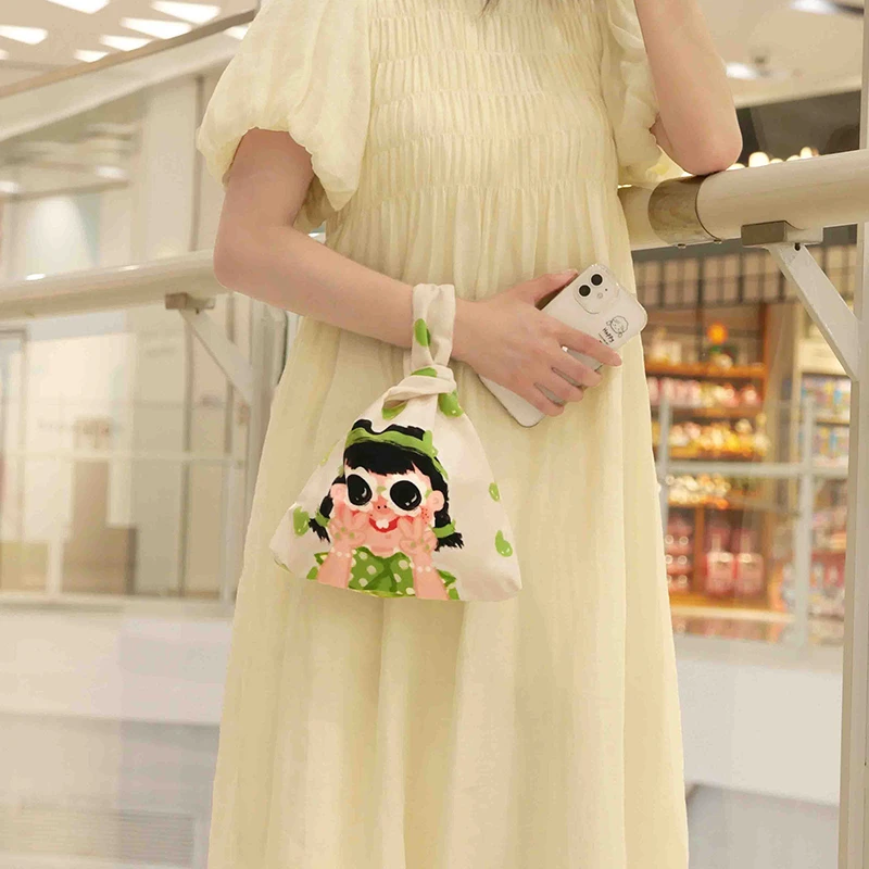 弘娜X仟精灵原创套结手腕包便携化妆包女士零钱袋卡通印花