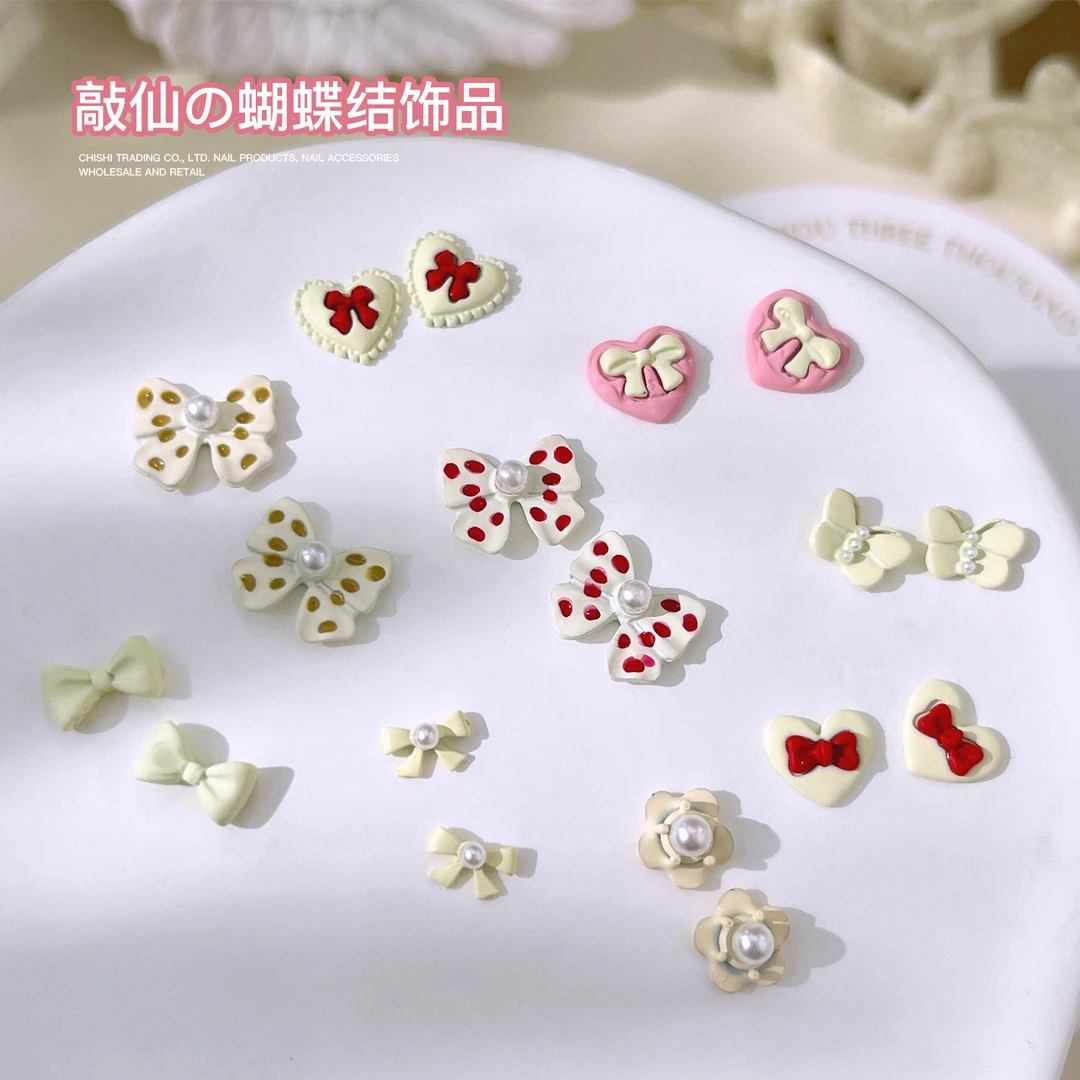 新款奶呼呼爱心蝴蝶结美甲饰品波点蝴蝶结爱心珍珠花花指甲钻批发